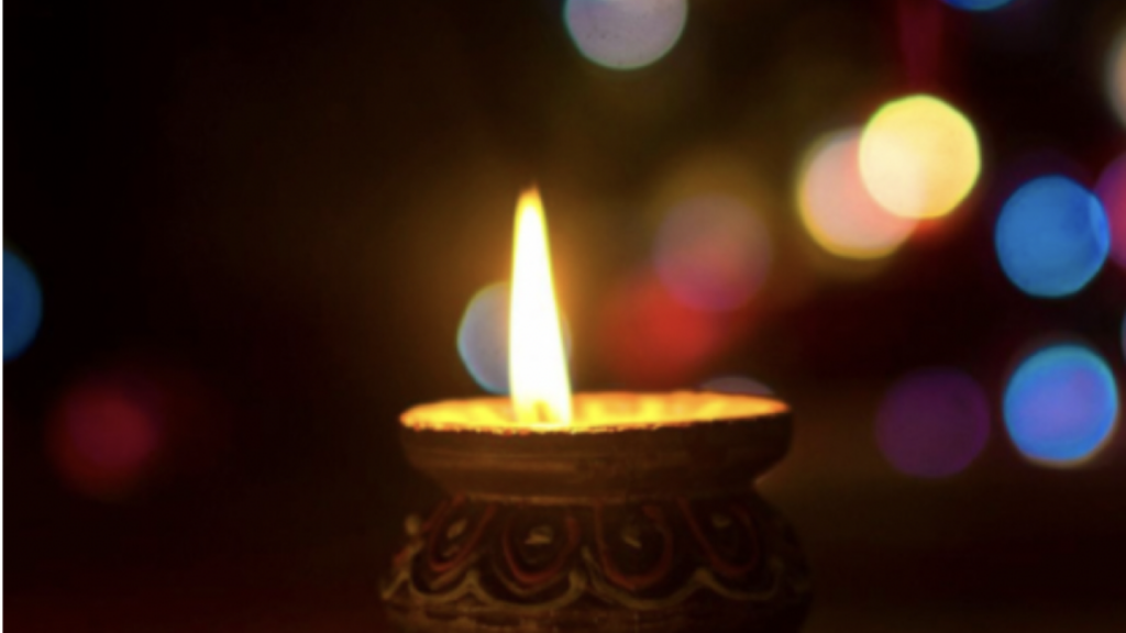 A small candle lit in the dark