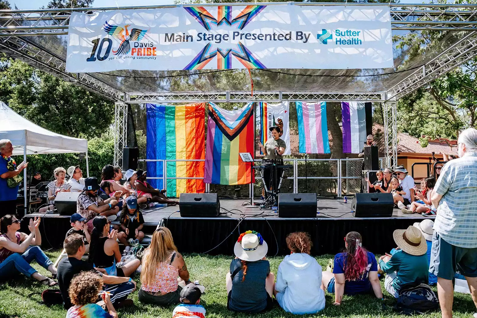People sitting in front of a stage for PrideFest
