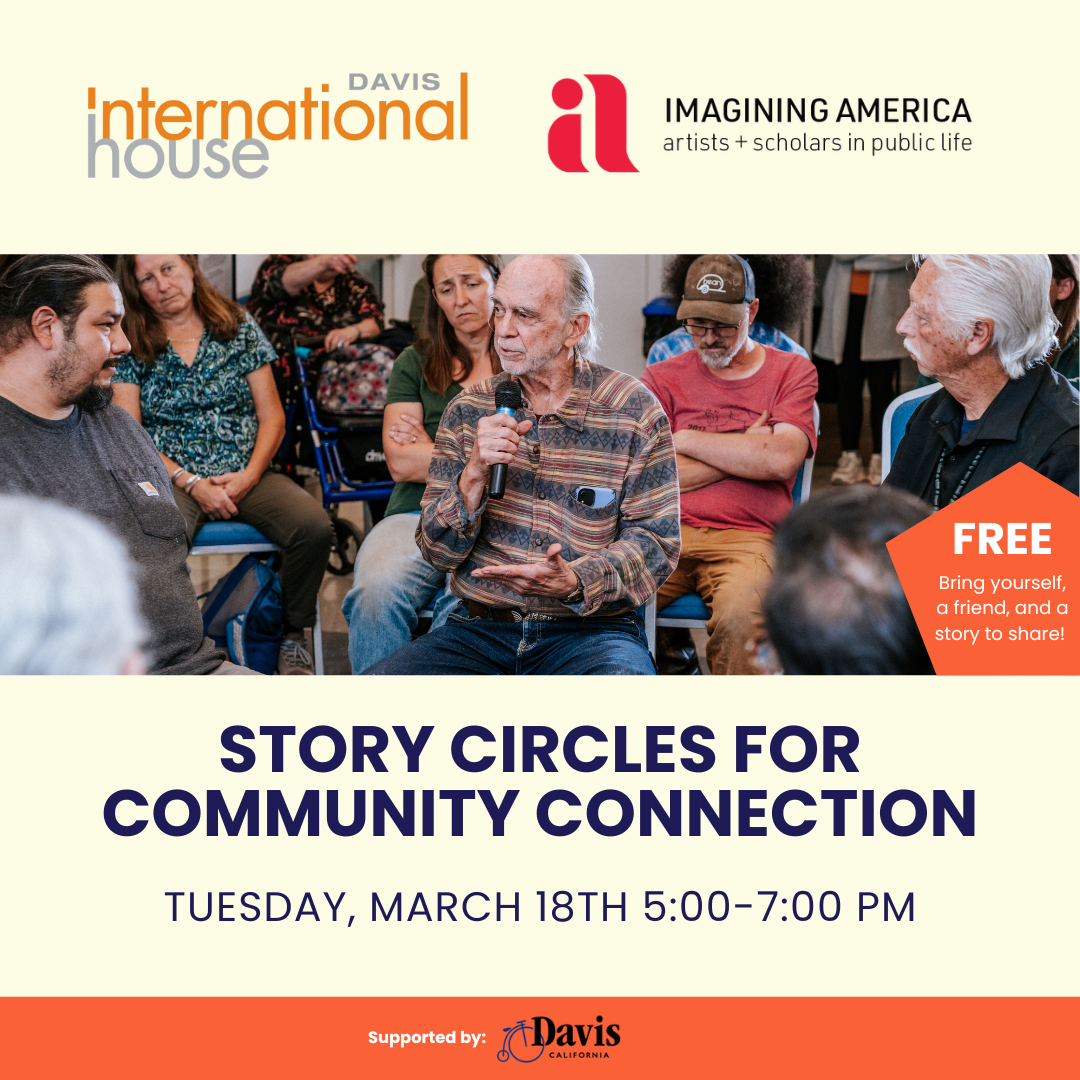 An elderly man speaks to a group of people in a circle